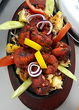 TANDOORI CHICKEN TIKA marinated chicken fillet, roasted in tandoor and garnished with vegetables
